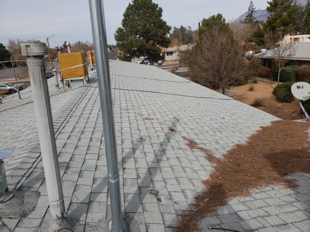 shingle roof with hail damage and debris